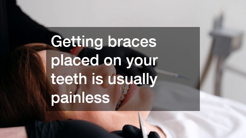 patient smiling while a dentist performs a braces procedure
