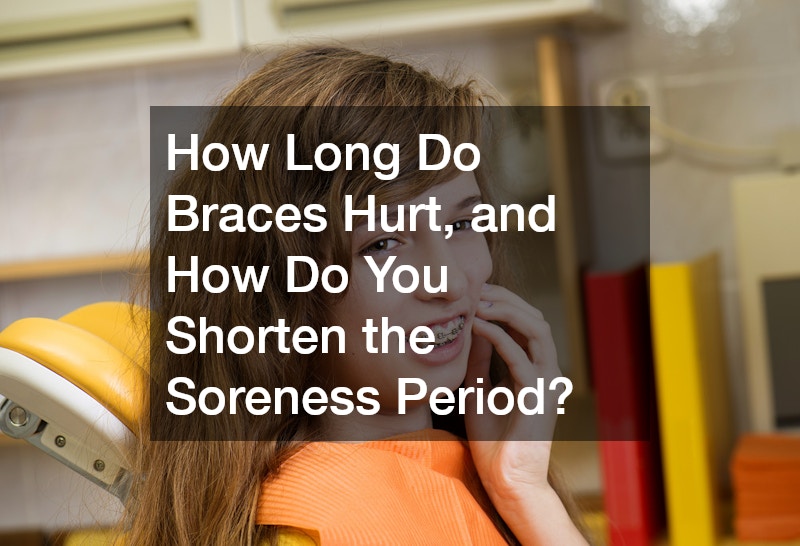 young woman with braces touching her cheek, showing a look of discomfort